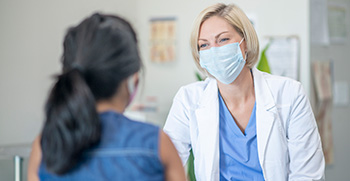 A small practice doctor having a pleasant visit with a patient