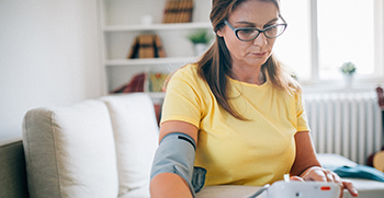 A woman having her blood pressure taken