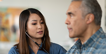 A doctor checking a patients breathing with a stethoscope